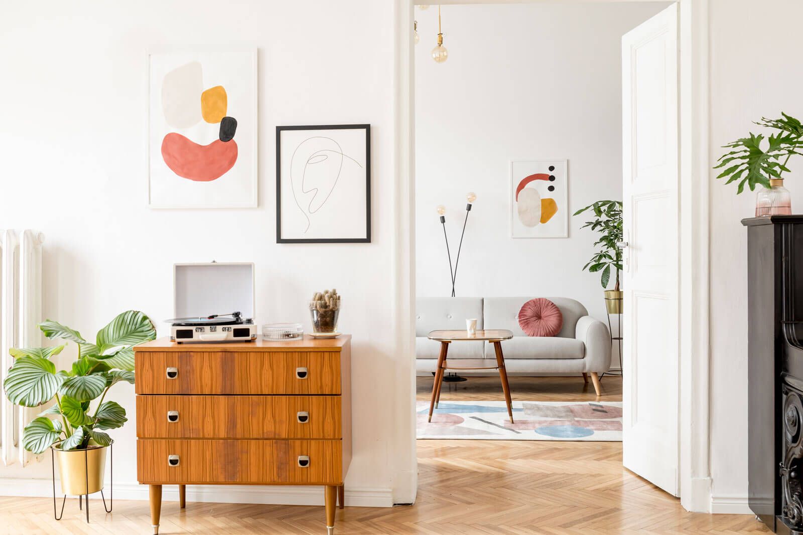 Cozy mid-century modern living space with wooden furniture and abstract wall art.