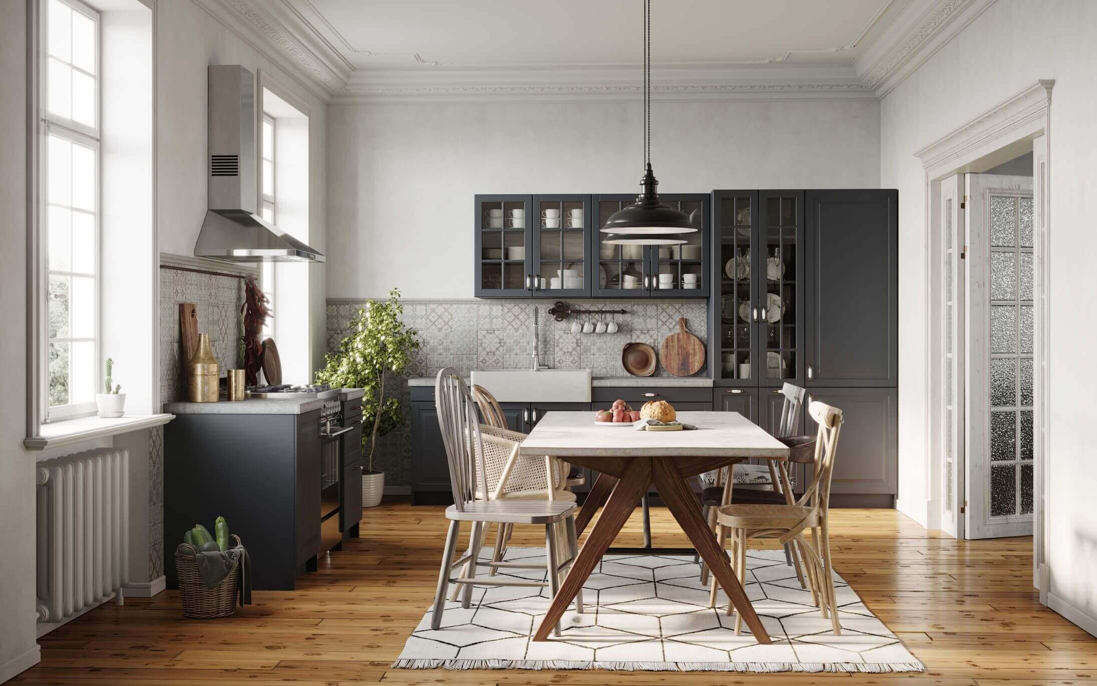Modern kitchen with a wooden dining table and gray cabinets.